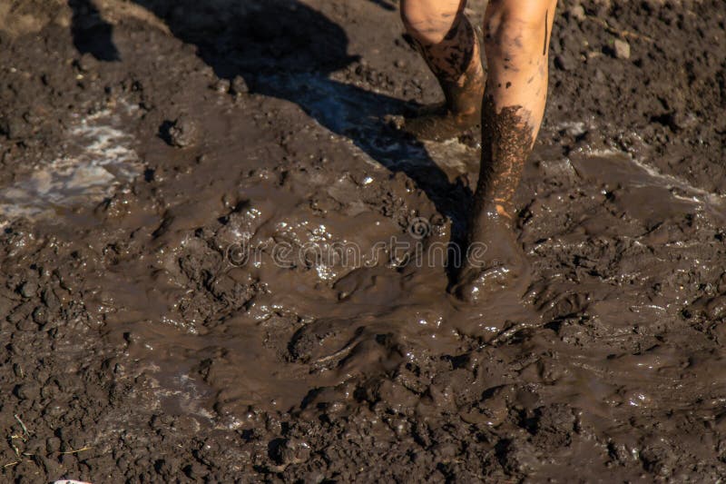 Child playing in mud. Selective focus. stock photography