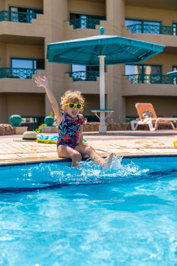 Child playing in the pool. Selective focus. stock image