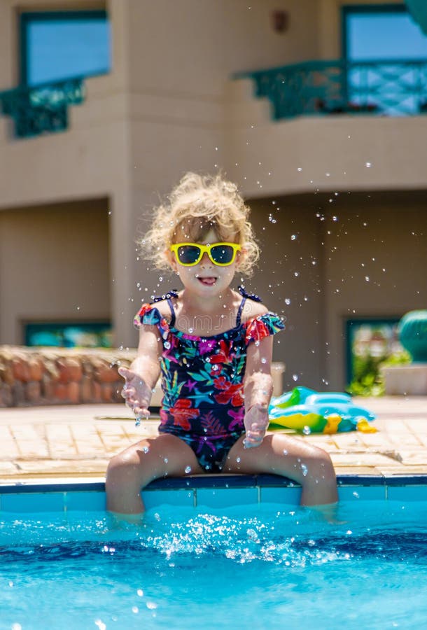 Child playing in the pool. Selective focus. stock photography