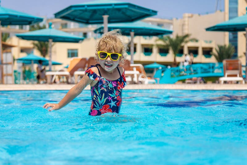 Child playing in the pool. Selective focus. stock image