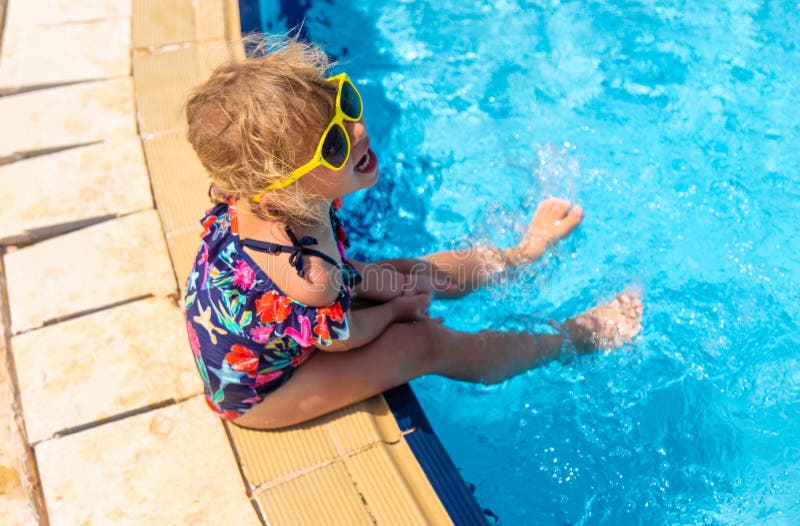 Child playing in the pool. Selective focus. stock photography