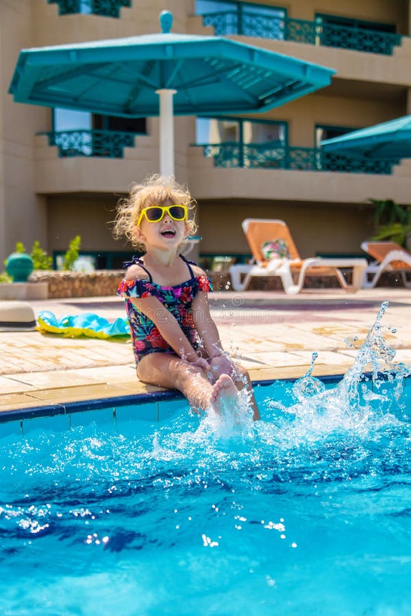 Child playing in the pool. Selective focus. stock image