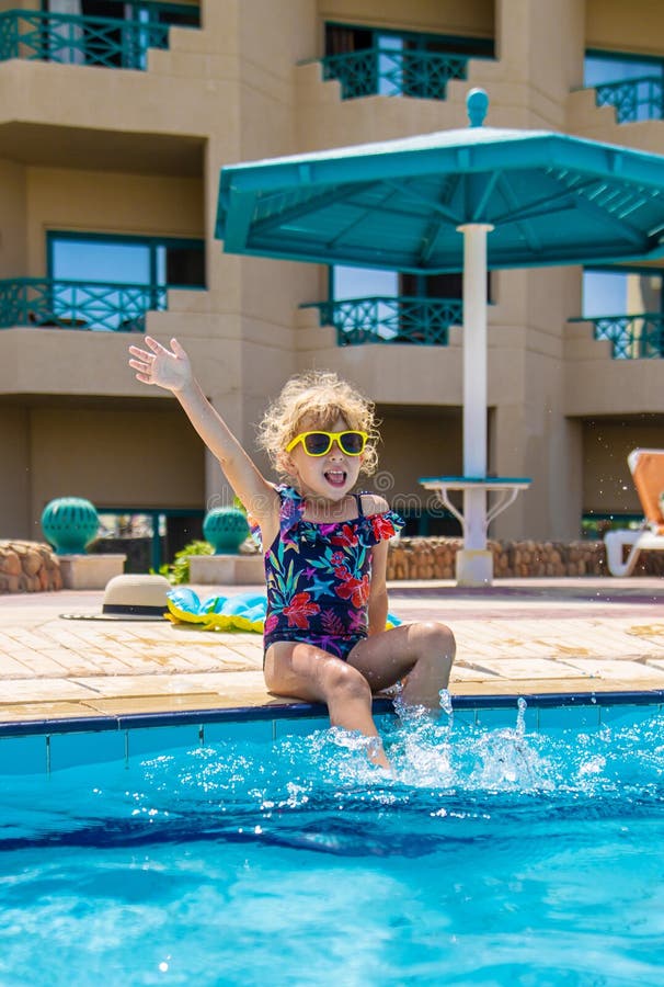 Child playing in the pool. Selective focus. stock image