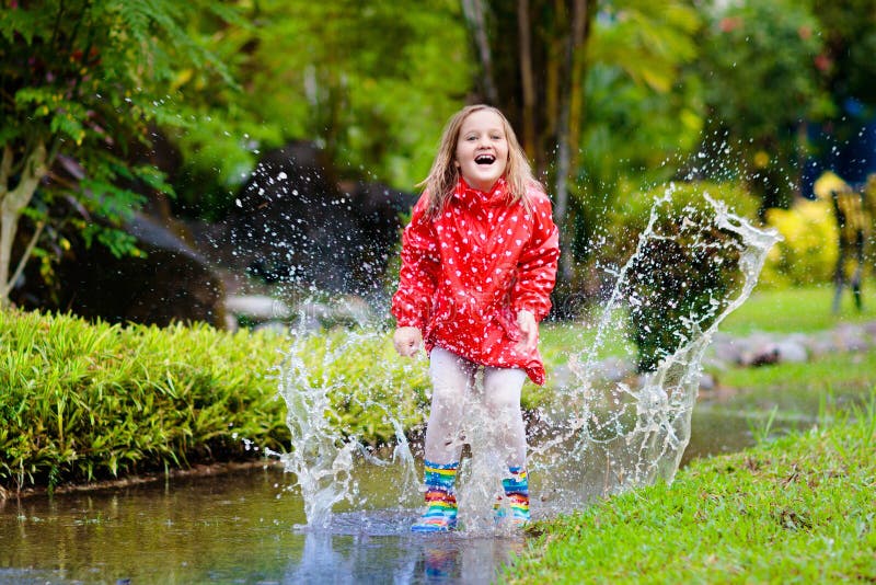 Child playing in puddle. 