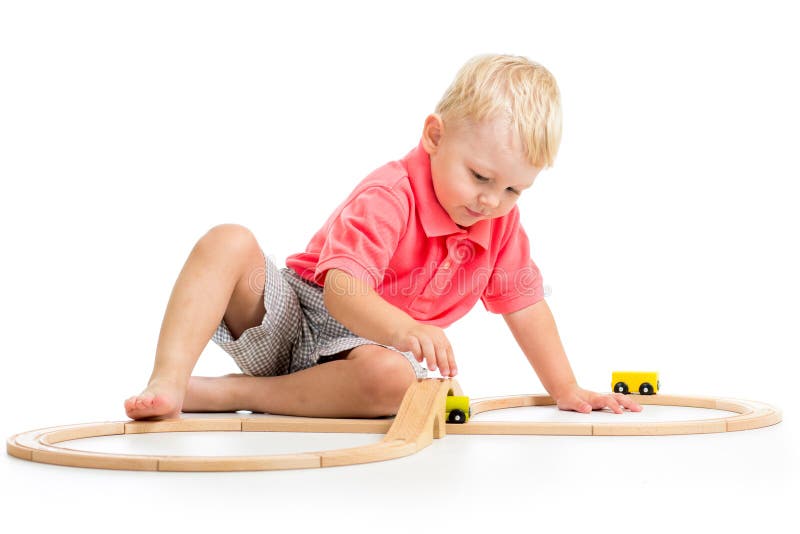 Child playing rail road toy