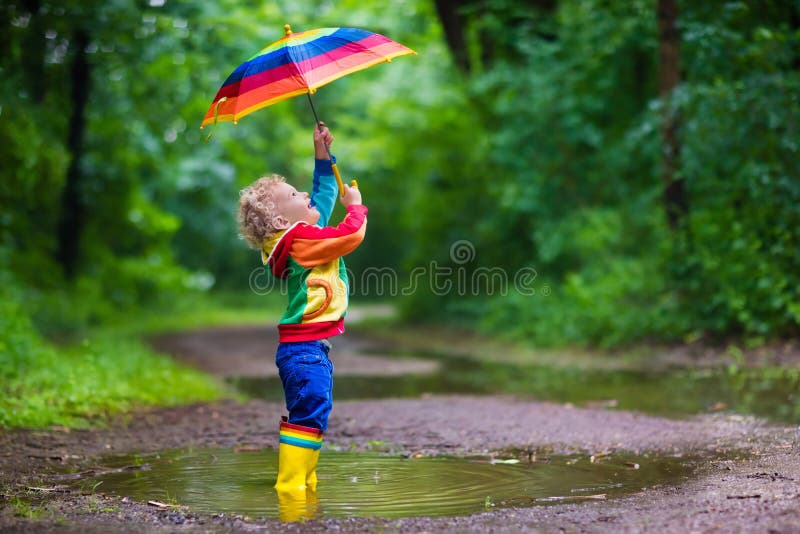 Child playing in the rain royalty free stock image
