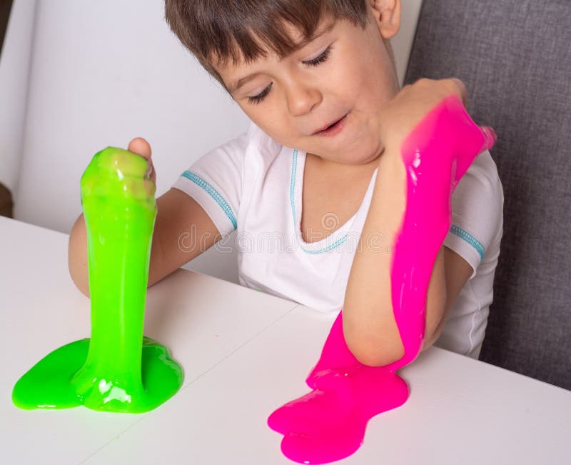 Child playing with slime. Kids squeeze and stretching slime. royalty free stock photo Child playing with slime. Kids squeeze and stretching slime. royalty free stock photo