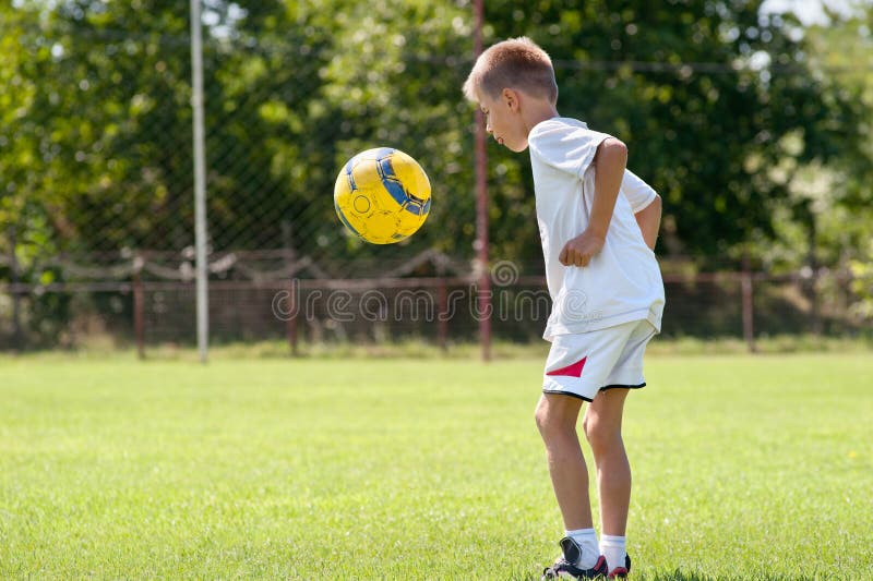 Child playing soccer ball