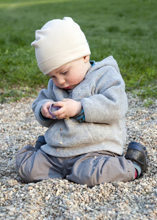 Child playing with stones