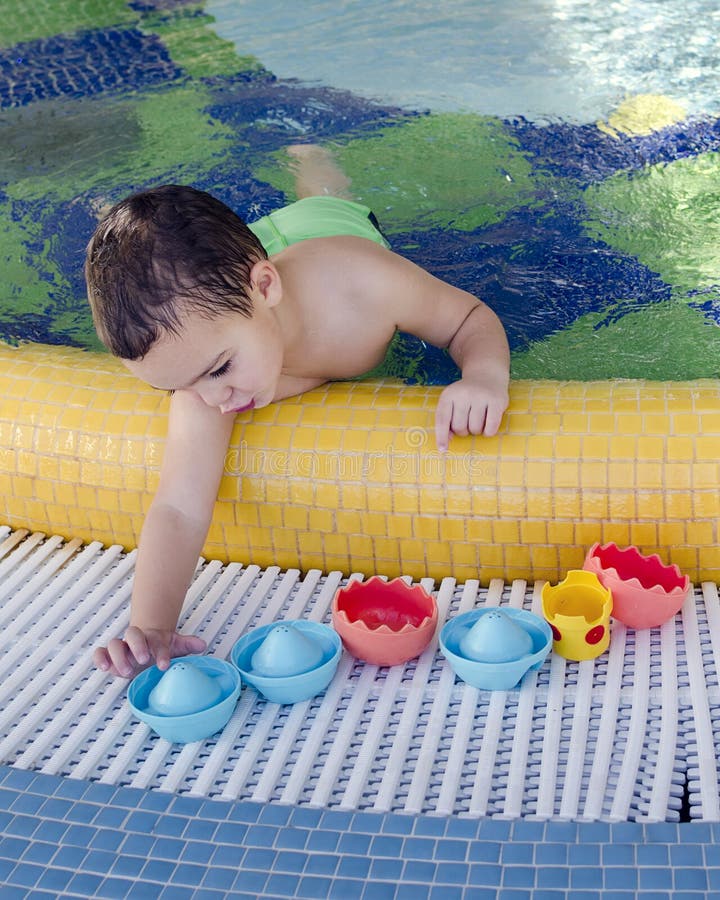 Child playing in swimming pool stock photo Child playing in swimming pool stock photo