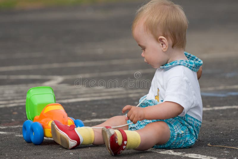 Child playing with toy truck