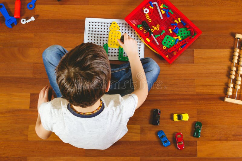 Little Boy Playing with Color Toys on Floor Stock Photo - Image of  bulldozer, little: 19039326