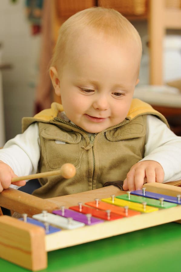 Child playing on xylophone