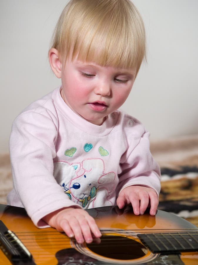 Child plays on guitar