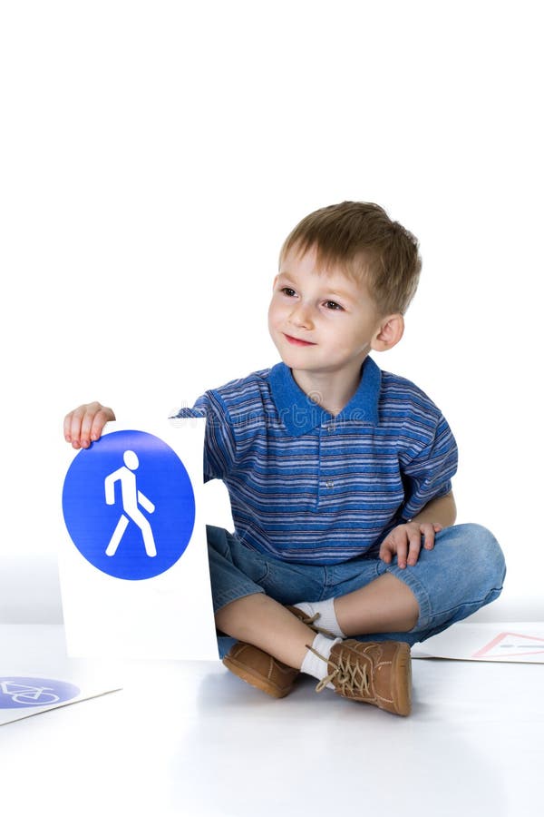 Child plays with traffic signs