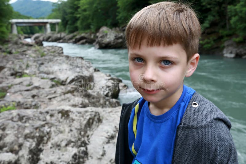 Child posing on bank of Belaya river in granite gorge royalty free stock images