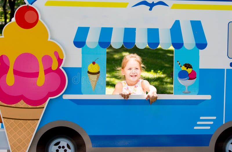Child Pretends To Sell Ice Cream from an Ice Cream Van Stock Photo
