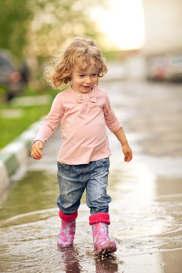 Cute child walking on puddle in autumn. Cute child walking on puddle in autumn