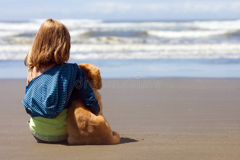 Child and Puppy at the beach stock photos