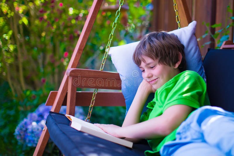 Child reading a book in the garden