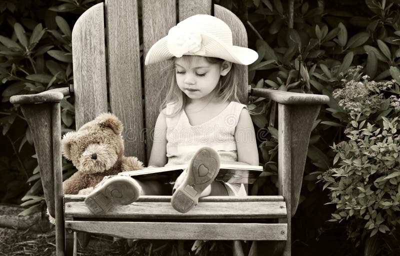 Child reading to her teddy bear