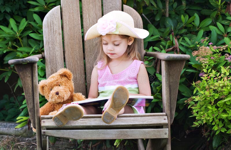 Child reading to teddy bear