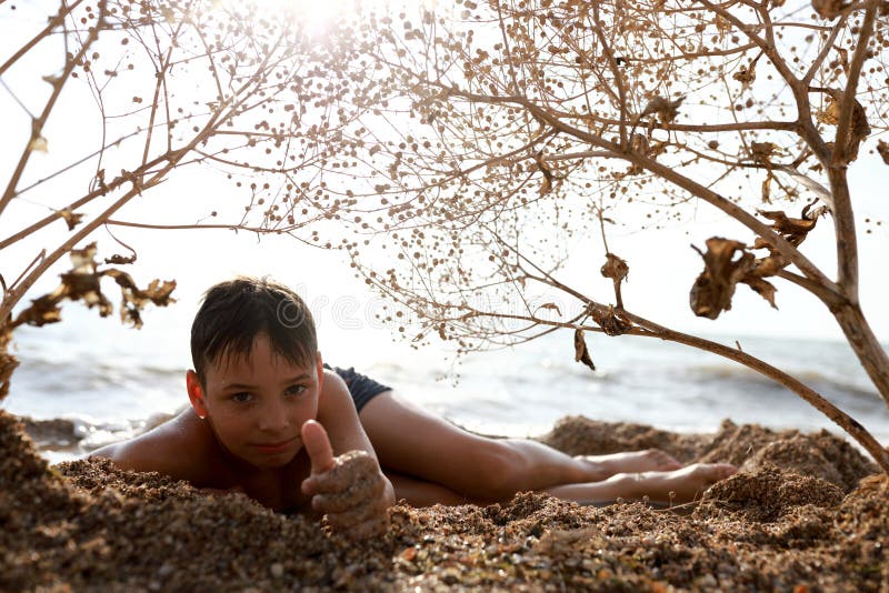 Child relaxing on beach of Azov sea