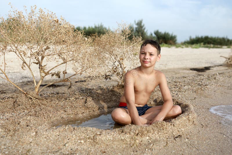 Child resting on beach of Azov sea