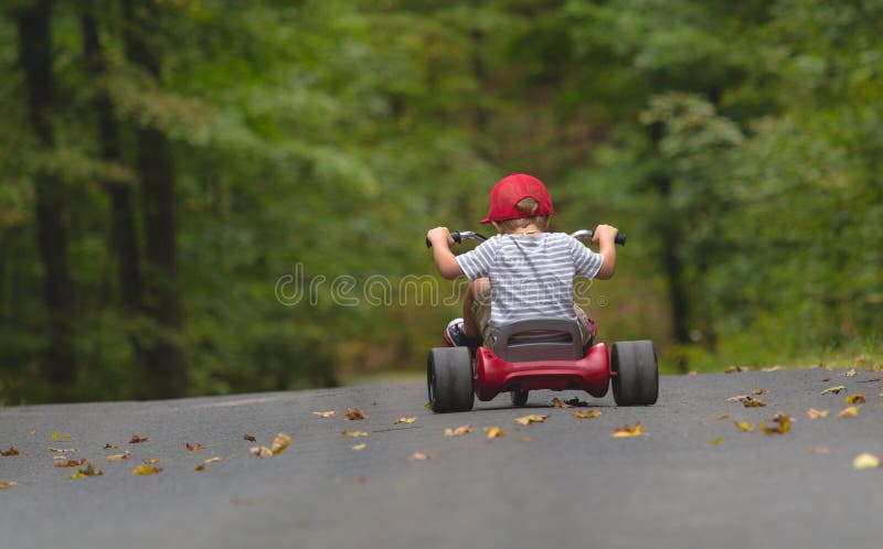 Child Riding a Big Wheel Bike