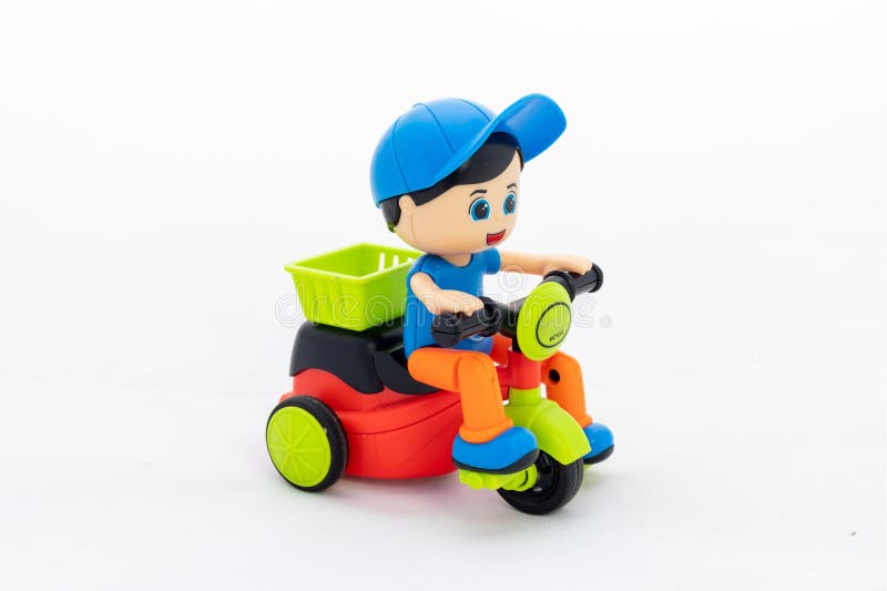 Child riding cycle toy for kids on white background.