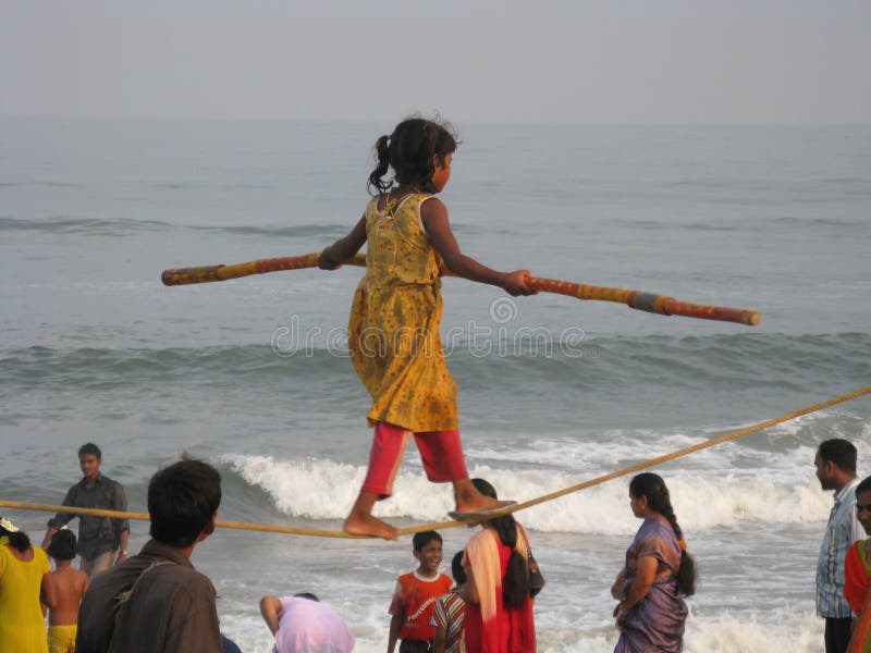 A child rope walker artist walking on a tight rope