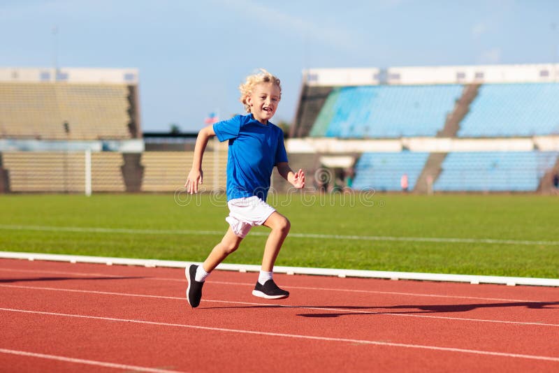 Child running in stadium. Kids run. Healthy sport stock images