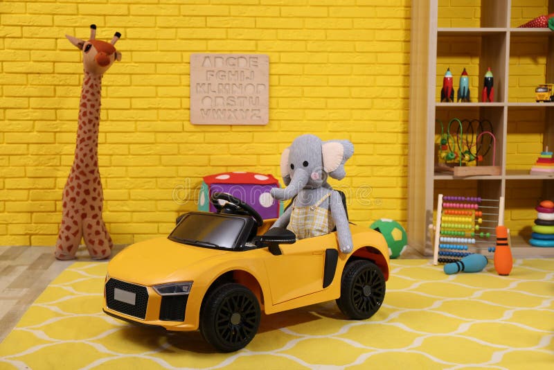 Child`s electric car with toy elephant