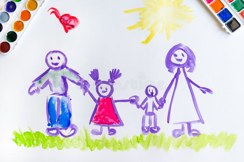 The top view of the child`s hand paints a sketch of the family with brush of watercolor on a white sheet of paper. The top view of the child`s hand paints a sketch of the family with brush of watercolor on a white sheet of paper
