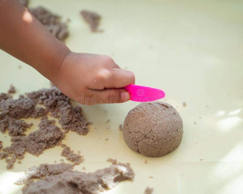 Child`s Hand Playing With Sand In Preschool. The Development Of