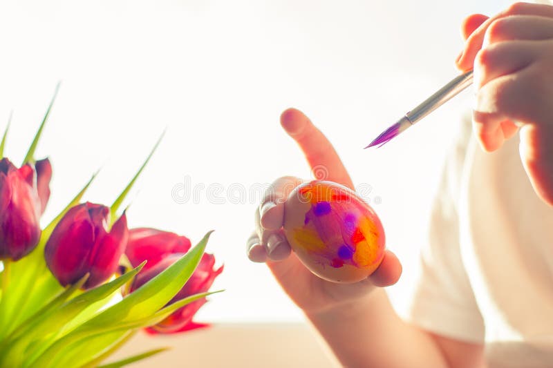 Child`s hands decorating Easter egg. Negative space. royalty free stock photography Child`s hands decorating Easter egg. Negative space. royalty free stock photography