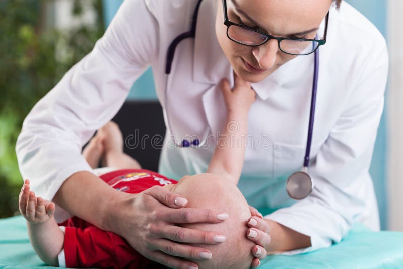 Child's neurologist diagnosing little boy stock photos