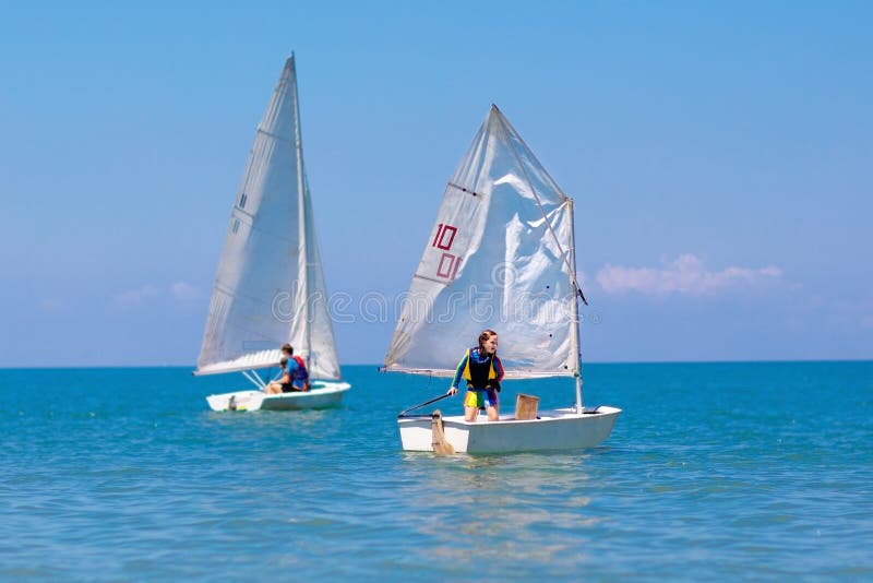 Child sailing. Kid learning to sail on sea yacht