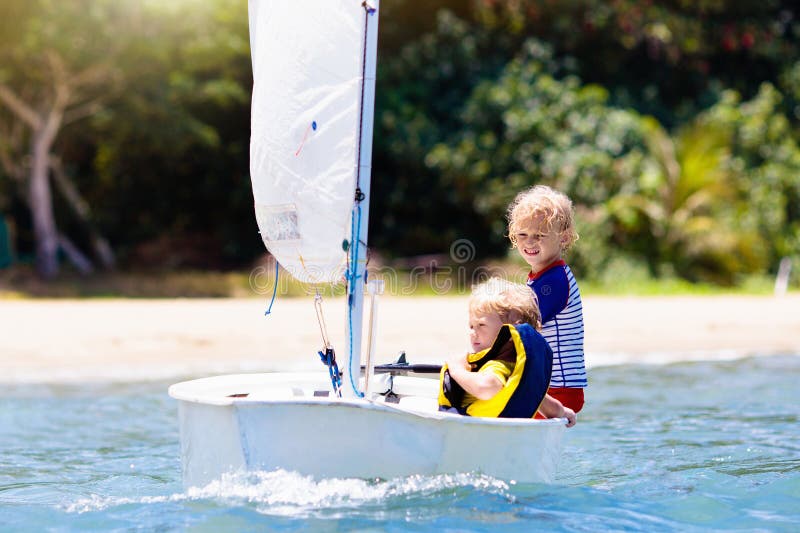 Child sailing. Kid learning to sail on sea yacht