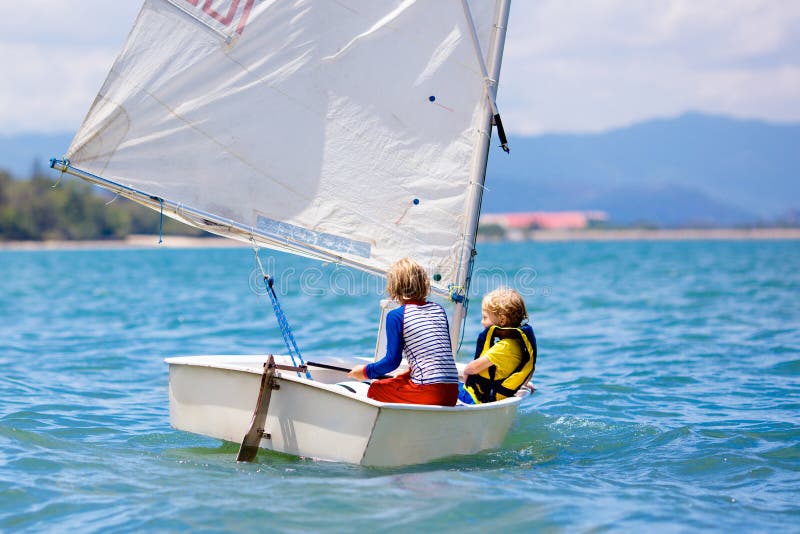 Child sailing. Kid learning to sail on sea yacht