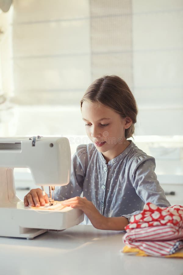Boy using a sewing machine stock photo. Image of indoors 6081586