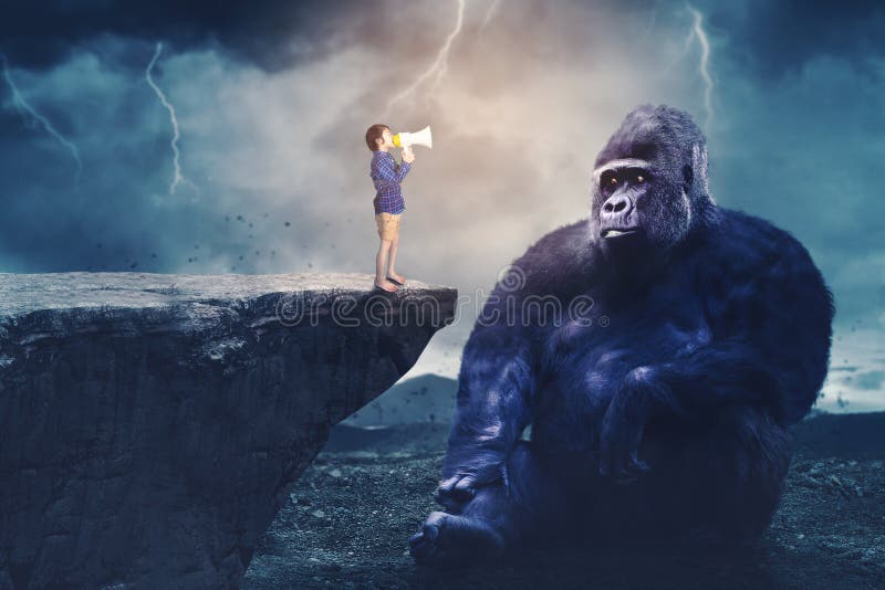 Child shouting at a big gorilla through a megaphone stock photo