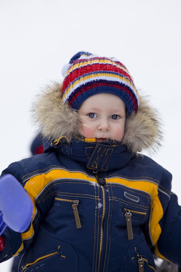 Child with Shovel Look at You in Winter Background Stock Photo - Image ...