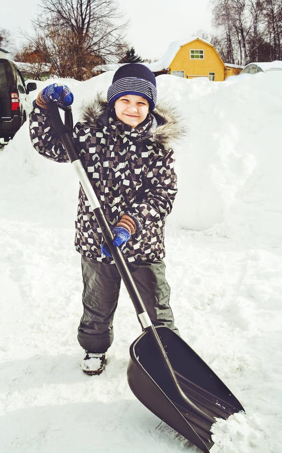 Child is Shoveling Snow in Front of His House. Stock Image Image of