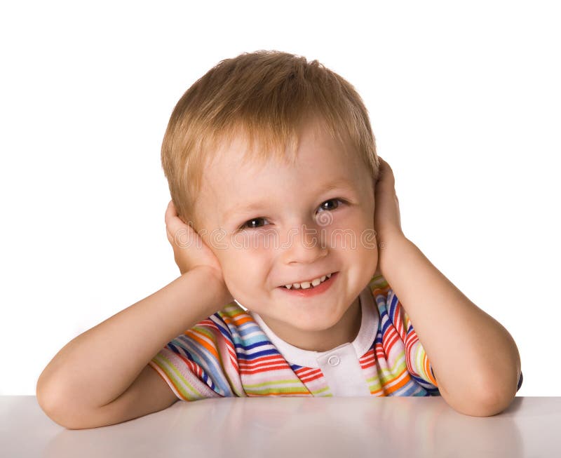 The child sits at a table