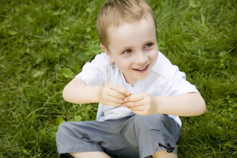 Child Sitting On The Grass