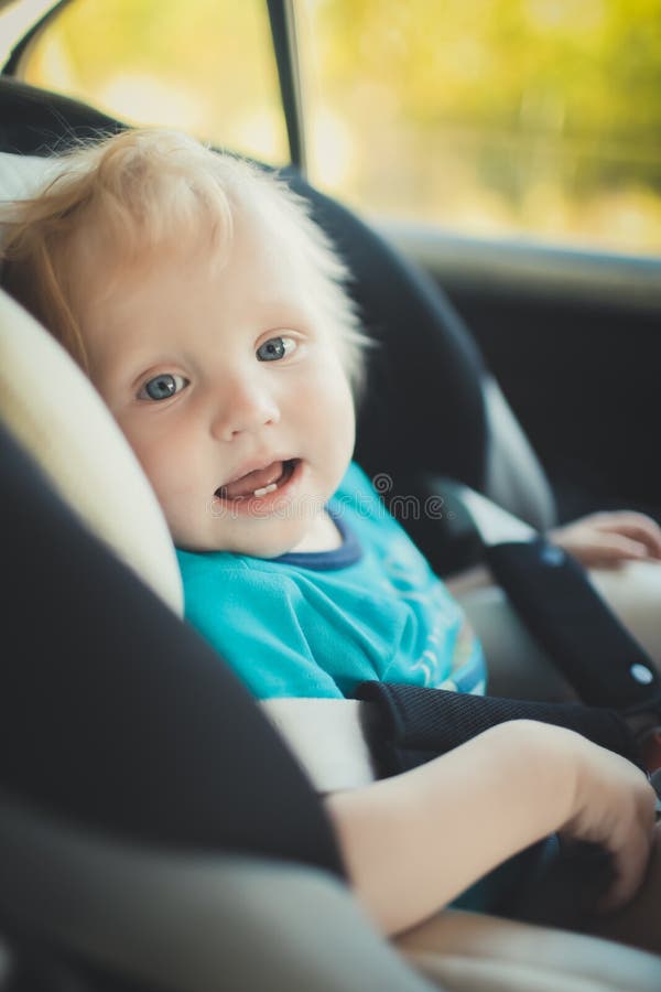 The Child is Sitting in a Child Seat in the Car. Stock Image Image of