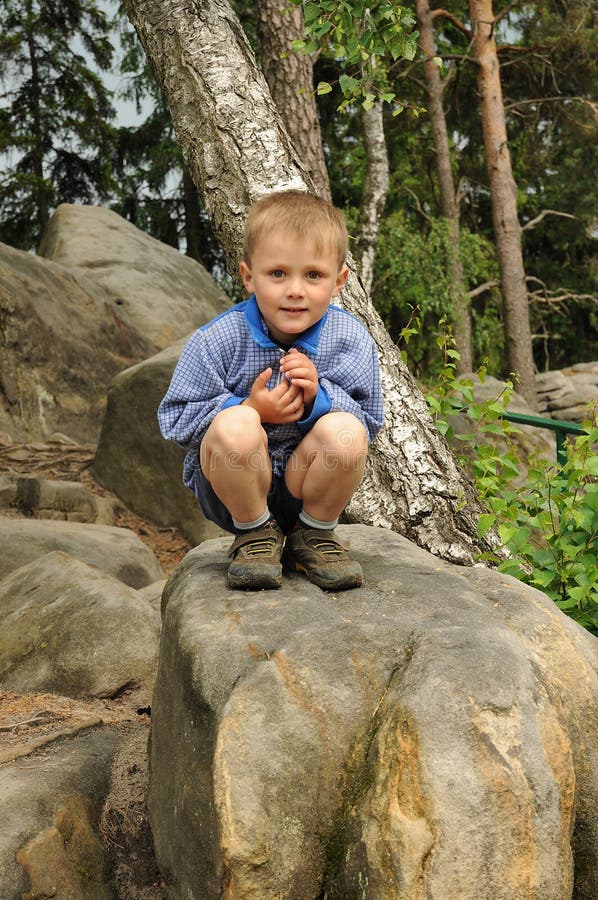 Child sitting on stone