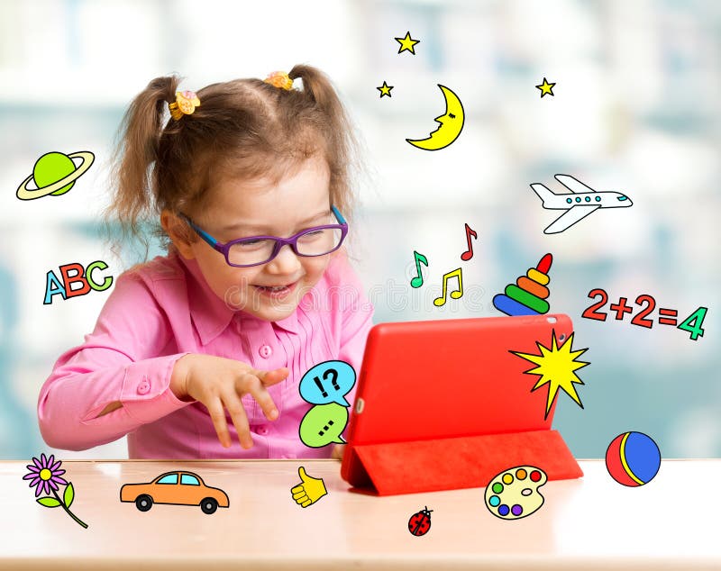 Child sitting with tablet computer and learning wi