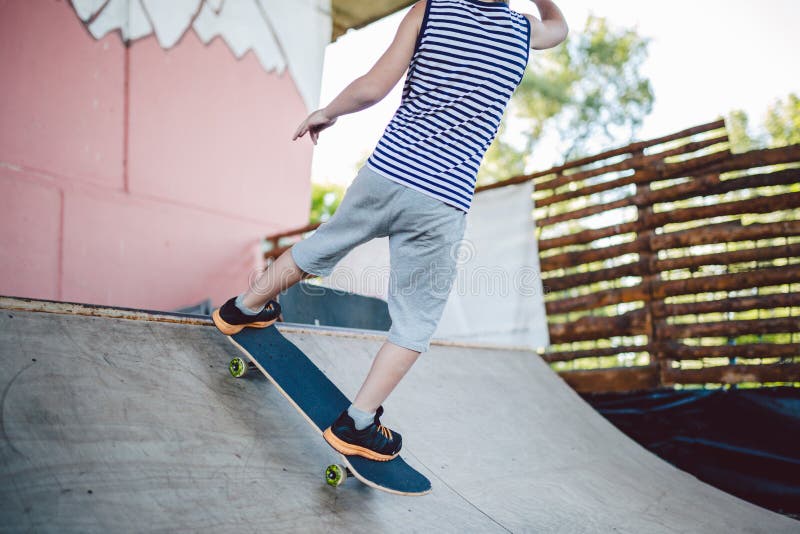 Skater Boy Rides on Skateboard at Skate Park Ramp. Kid Practising ...